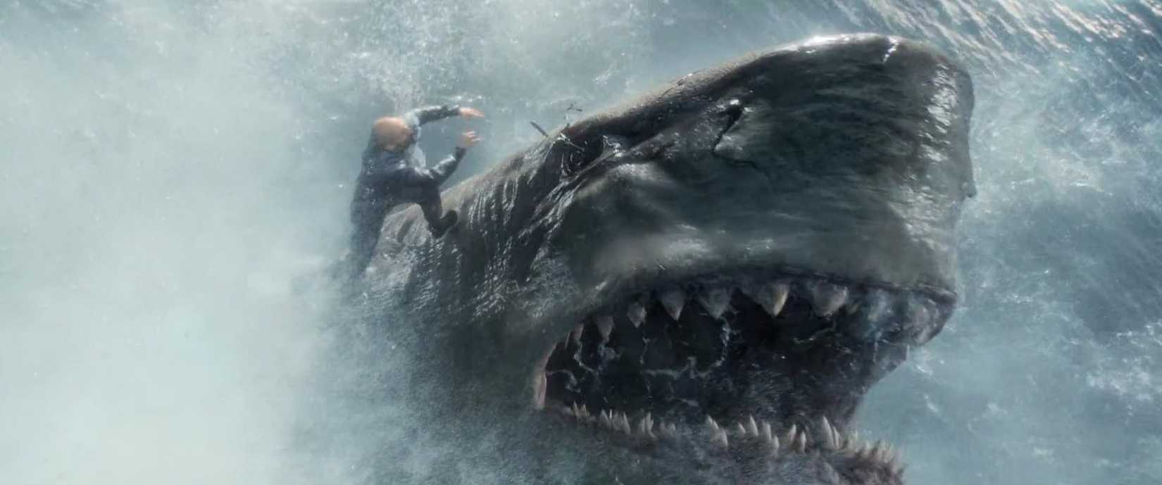 Jonas Taylor (Jason Statham) stabbing a megalodon shark in the eye with a spear in The Meg.