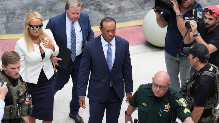 Golfer Tiger Woods, right, leaves with Vanessa Trump, left, after Woods' plea conference hearing in a DUI case stemming from a rollover crash in Florida in March.