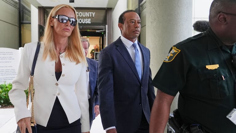Golfer Tiger Woods, right, leaves with Vanessa Trump, left, after Woods' plea conference hearing in a DUI case stemming from a rollover crash in Florida in March.