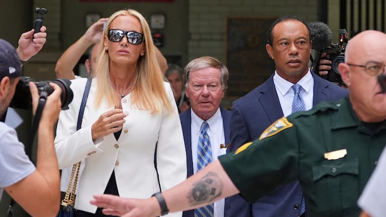 Golfer Tiger Woods, right, leaves with Vanessa Trump, left, after Woods' plea conference hearing in a DUI case stemming from a rollover crash in Florida in March.