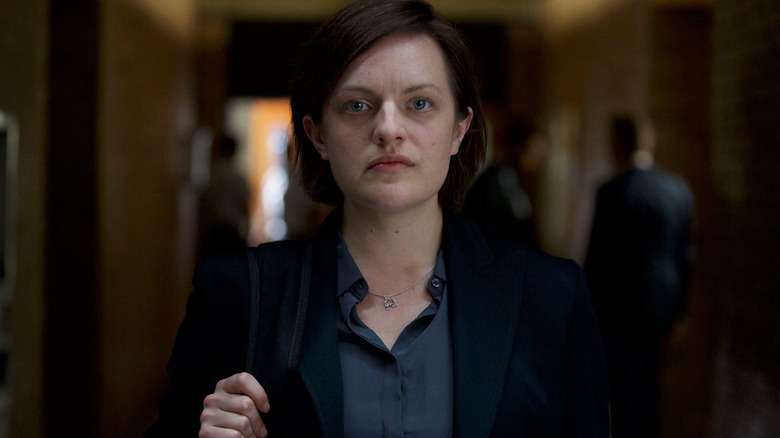 Robin (Elisabeth Moss) standing in a hallway on 