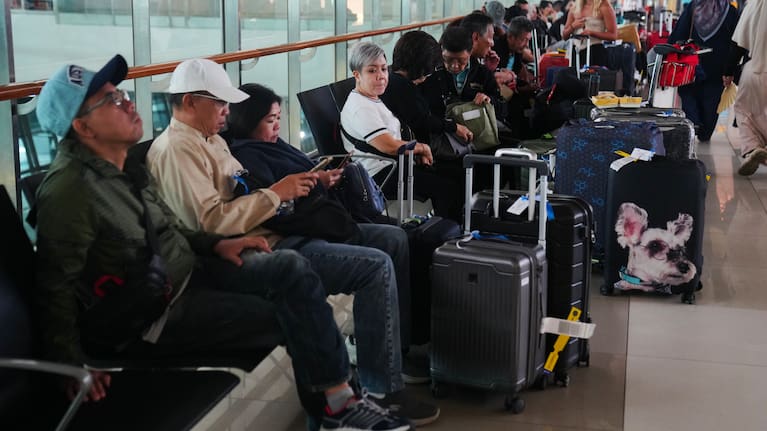 Travelers wait for their flights at Soekarno-Hatta International Airport in Tangerang, Indonesia, Sunday, Sept. 6, 2026.