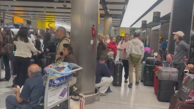 Travellers pictured inside Heathrow Airport. 