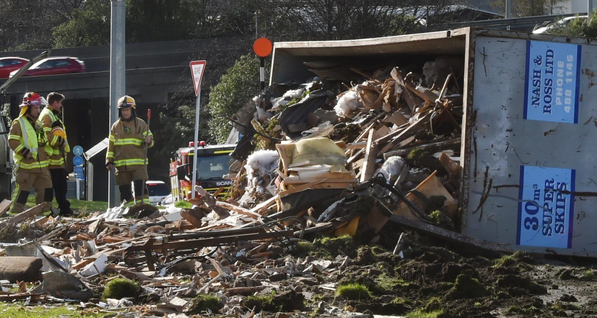 One in serious condition as truck rolls and spills load in Dunedin