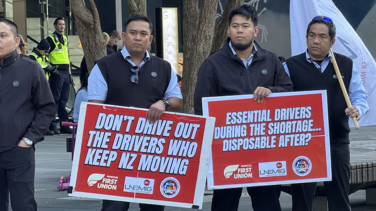 Two migrant bus drivers at a rally in the Auckland CBD.