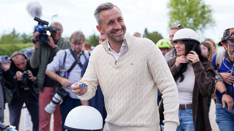 Ulrich Siegmund, top candidate for the "Alternative for Germany" (AfD) party holds his motorcycle keys in party colors after voting at a polling station.