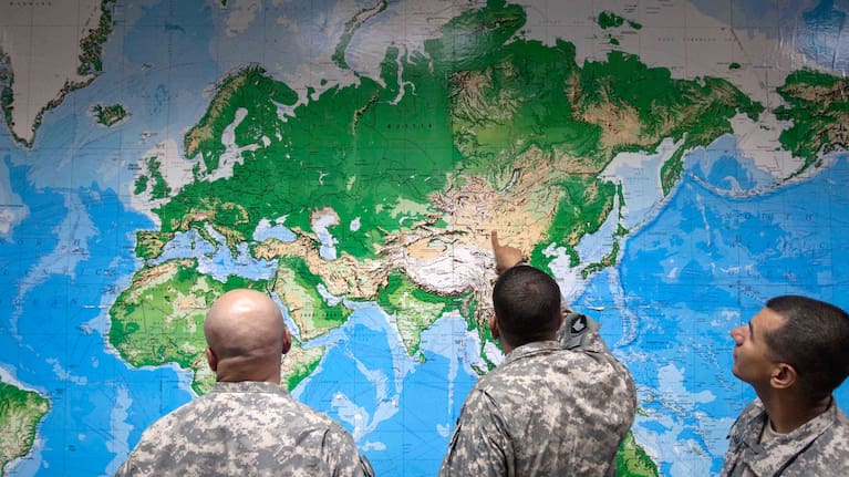 Soldiers look at a world map (file photo). 