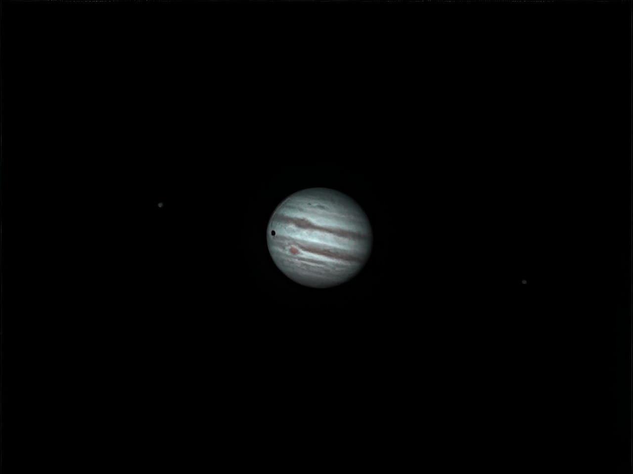 Jupiter with the moons Io (right) and Ganymede (left) early Tuesday.