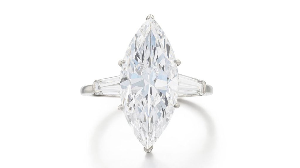 This Van Cleef & Arpels ring features a marquise-cut, 5.54-carat, D, VVS1 diamond, with baguette-cut diamond shoulders at Sotheby's image