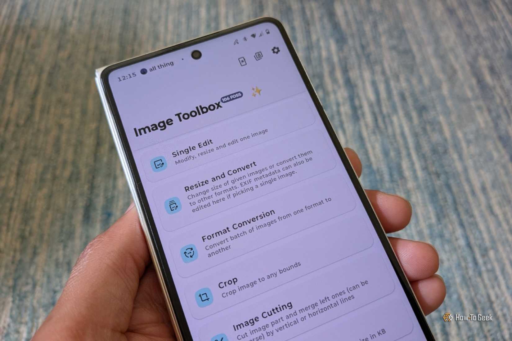 Hand holding an Android phone displaying the Image Toolbox app.