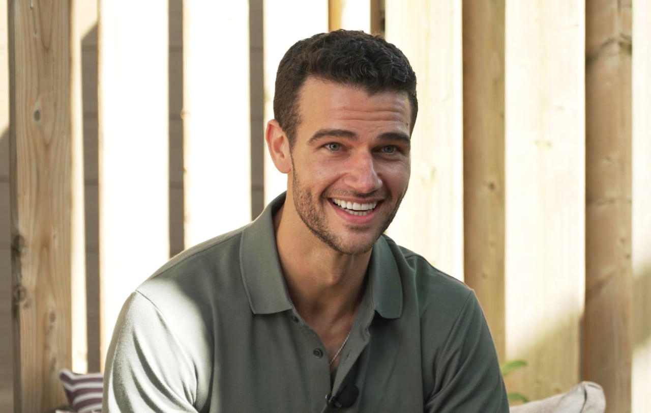 A young man in a green shirt.