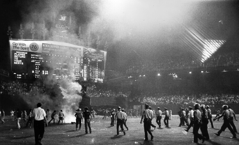 Police sweep the field at Comiskey Park amid flames and smoke in center field during the infamous WLUP-FM “Disco Demolition” stunt in 1979. | Jack Lenahan / Sun-Times