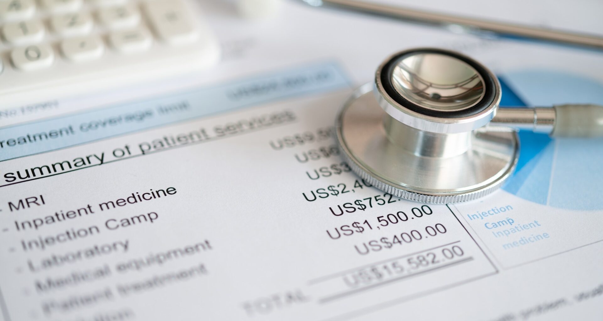 Medical treatment expense on bill statement with calculator and stathoscope.