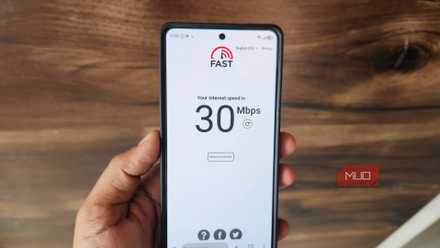 Phone in hand showing internet speed test