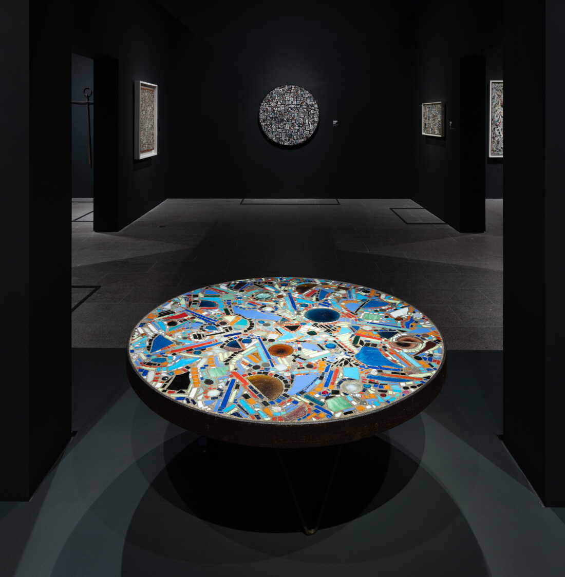 Lee Krasner, Mosaic Table, 1947 Mosaic of mixed media (including broken glass, keys, coins, ceramic, and pebbles) in cement; iron wagon-wheel armature with steel