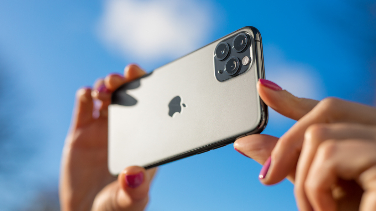 A person taking a picture with an iPhone