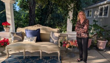 Award-winning photographer Diane Miller stands in her home studio beneath a covered balcony walkway. // SB Williams