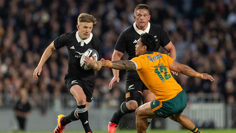 Damian McKenzie of New Zealand gets past Len Ikitau of Australia during the Bledisloe Cup Test match at Eden park in Auckland.