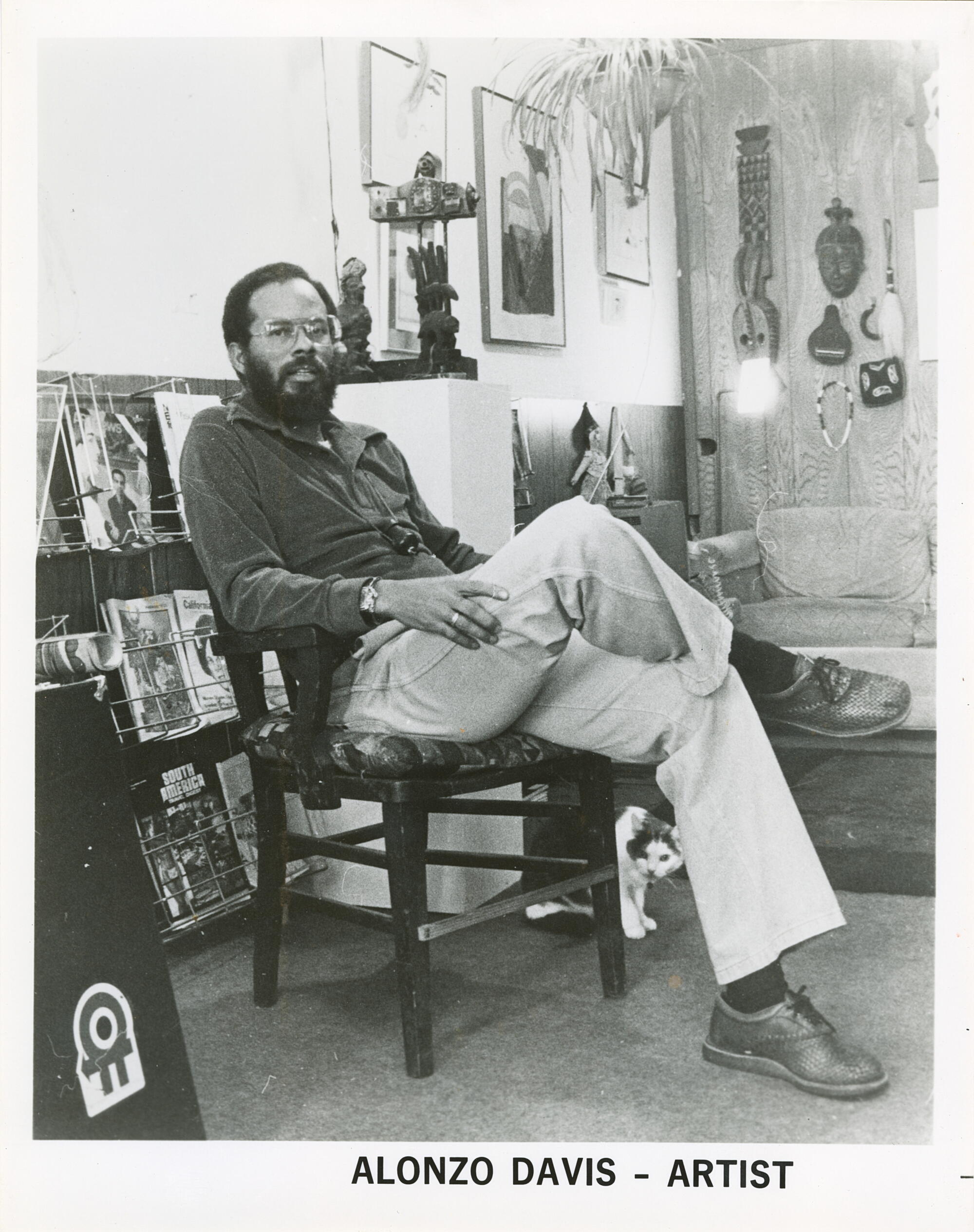 A man sits with his legs crossed at the knee.
