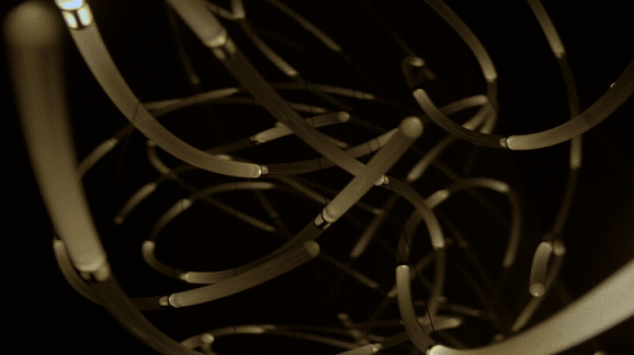 a gif of details of a suspended LED light sculpture with luminescence moving through undulating tubes