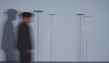 kinetic thread column transforms human presence into shifting shadows