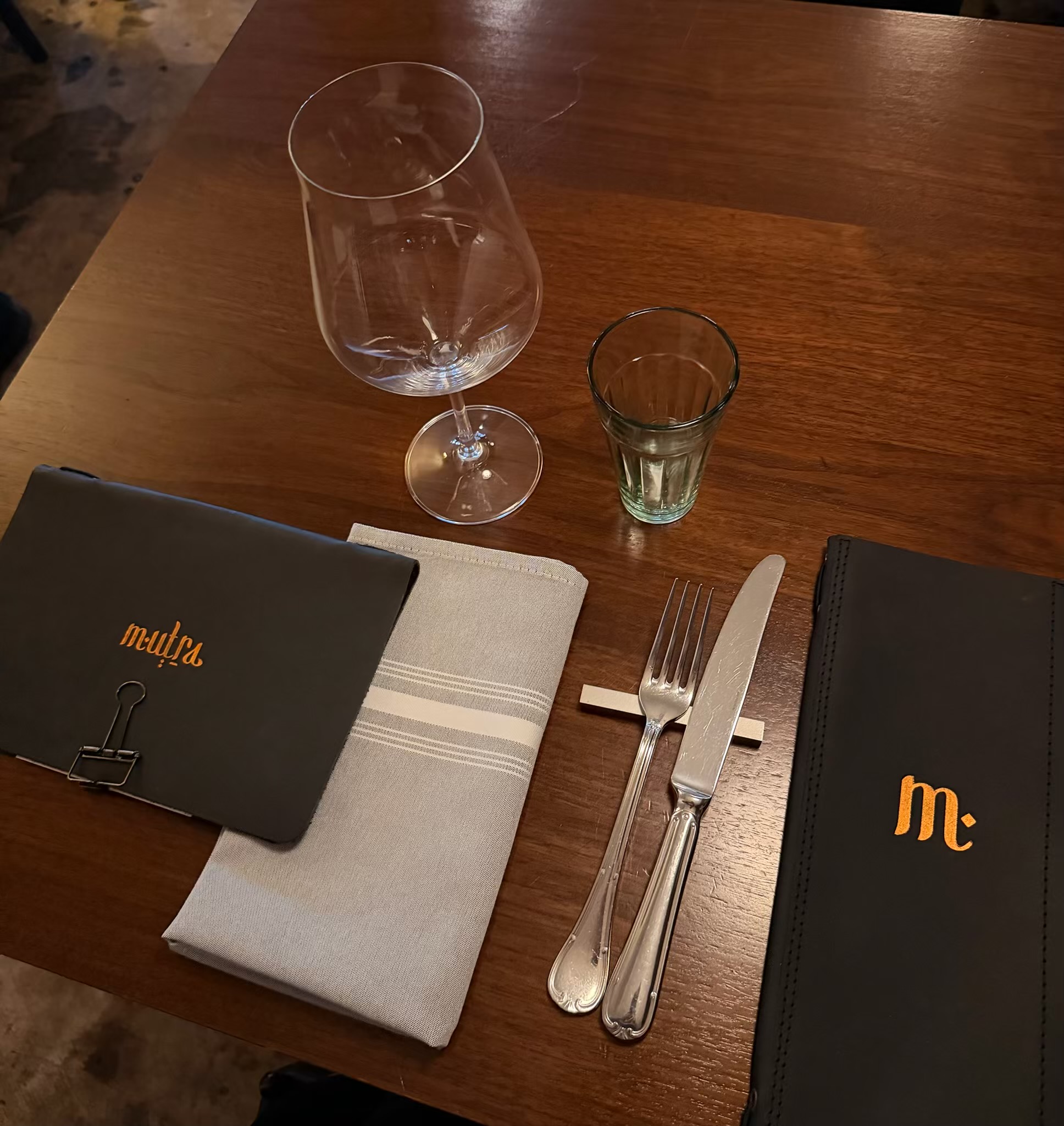 A table setting with menus at Mutra in North Miami
