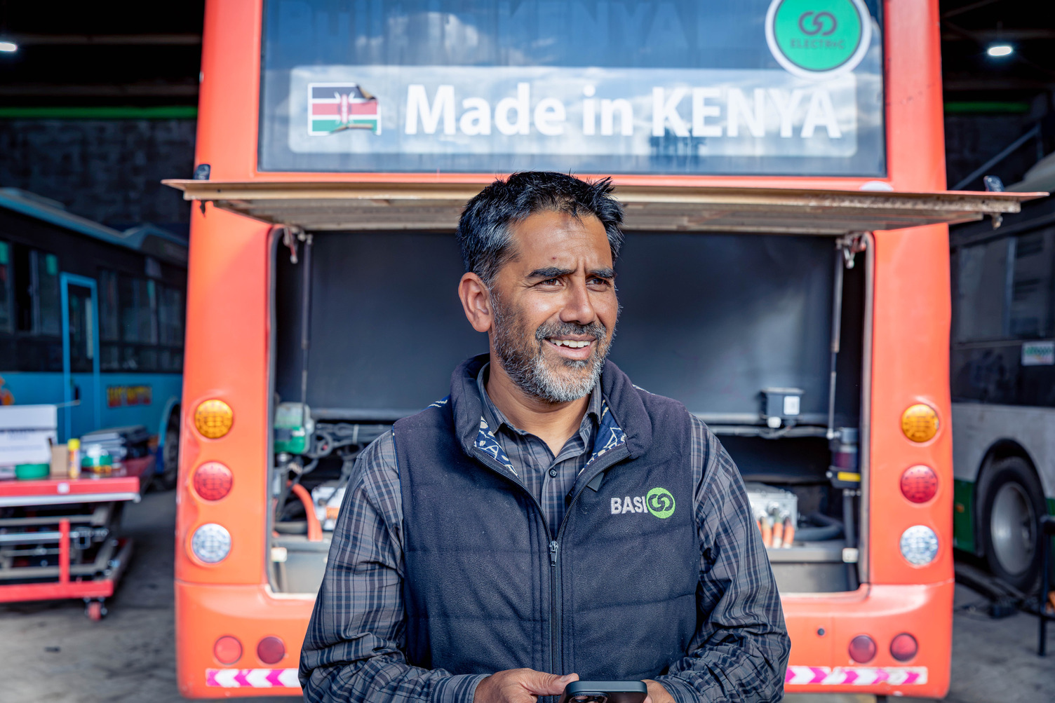 A man standing in front of a bus