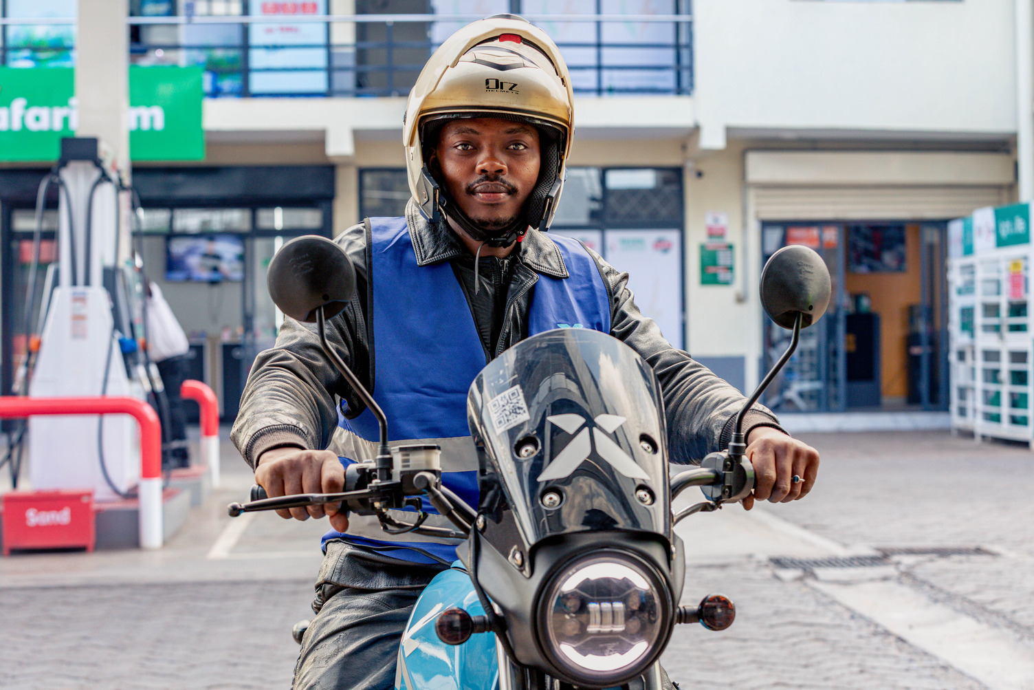 A motorcycle rider sits on his bike