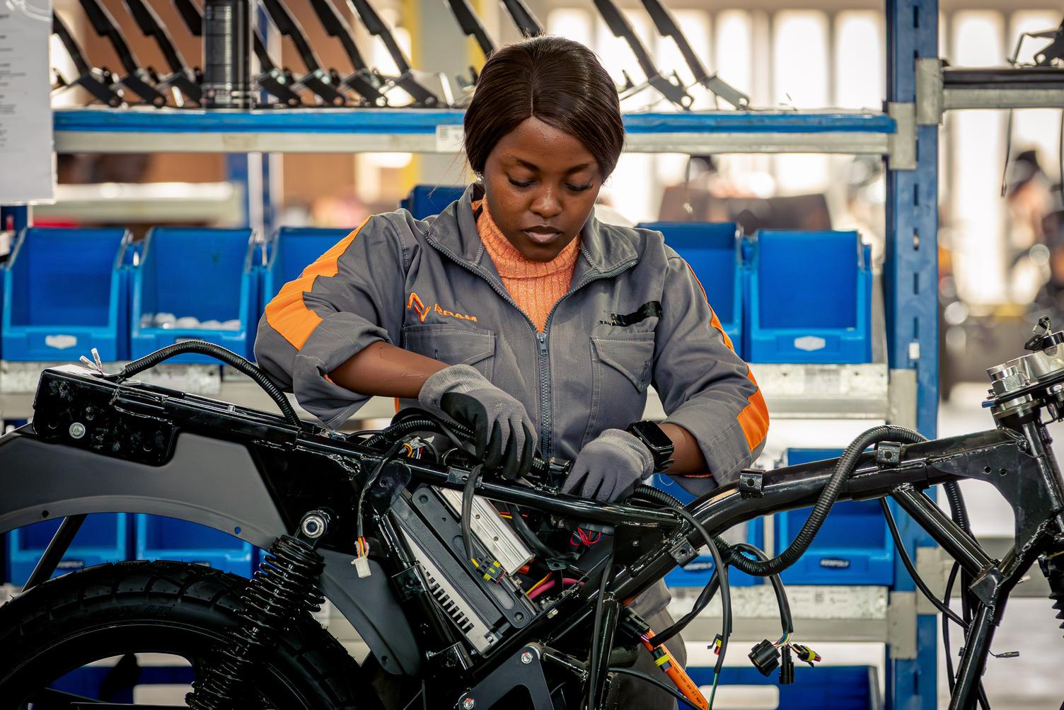 A woman assembles a motorcyle