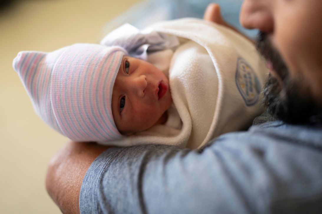 Emmanuel Verdin is cradled in his father's arms shortly after his birth.