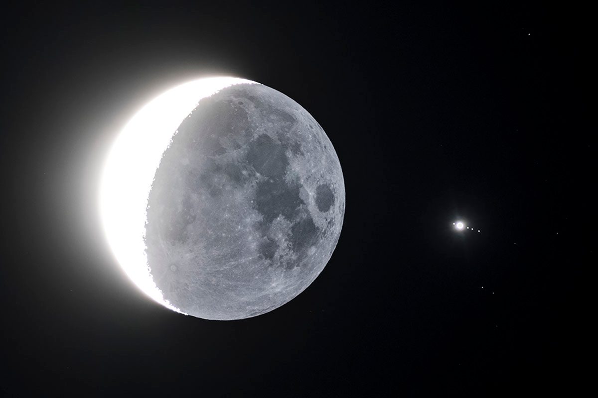 A view of the crescent Moon and Jupiter, with Jupiter