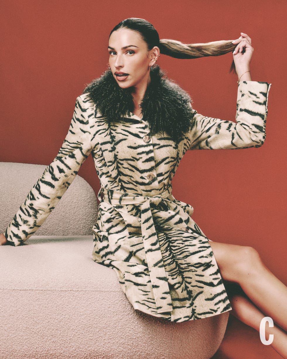 zara sat on a sofa in zebra coat zara sat on a sofa in zebra coat