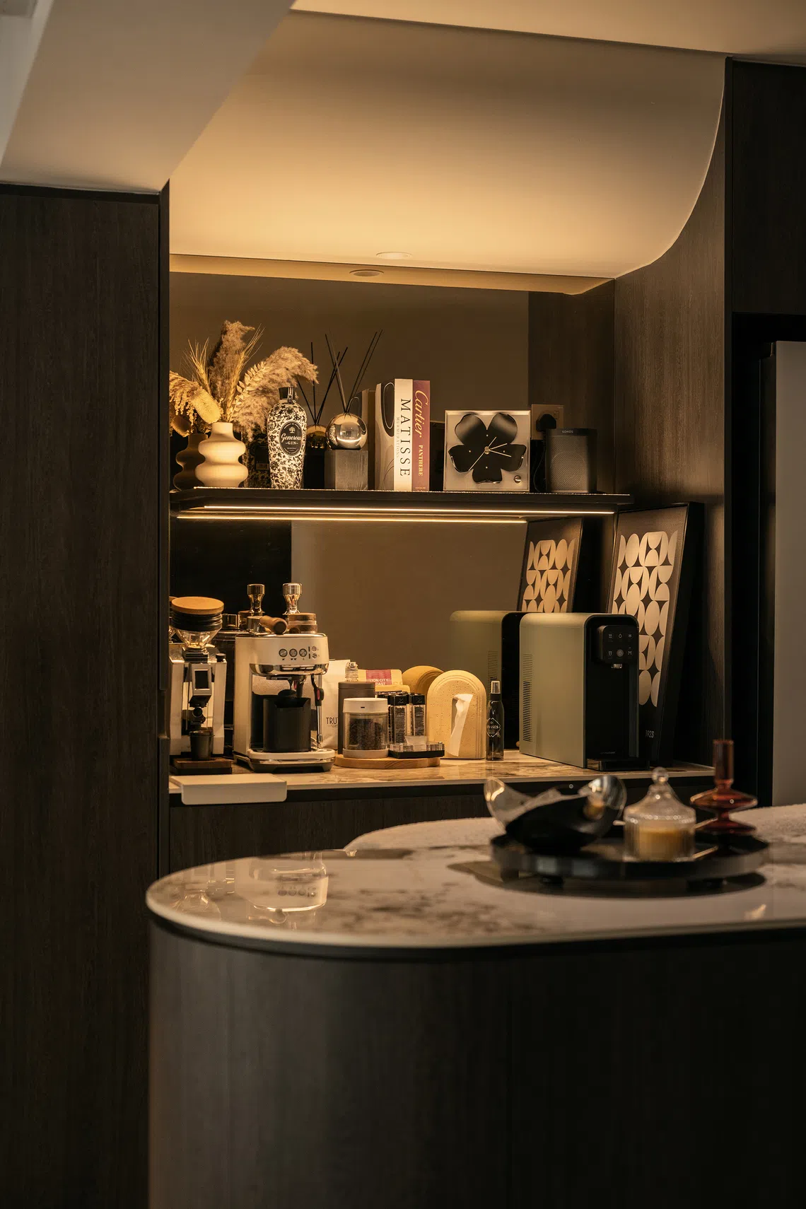 An unused mould has been repurposed as a bulkhead to conceal pipes above the dry pantry, which doubles as a personal “cafe”.