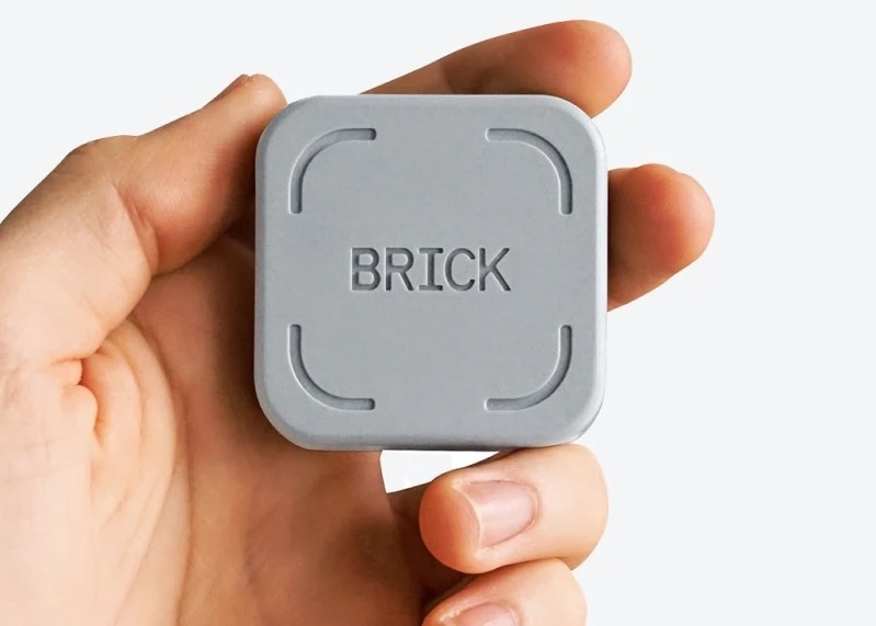 A handing holding the gray Brick.