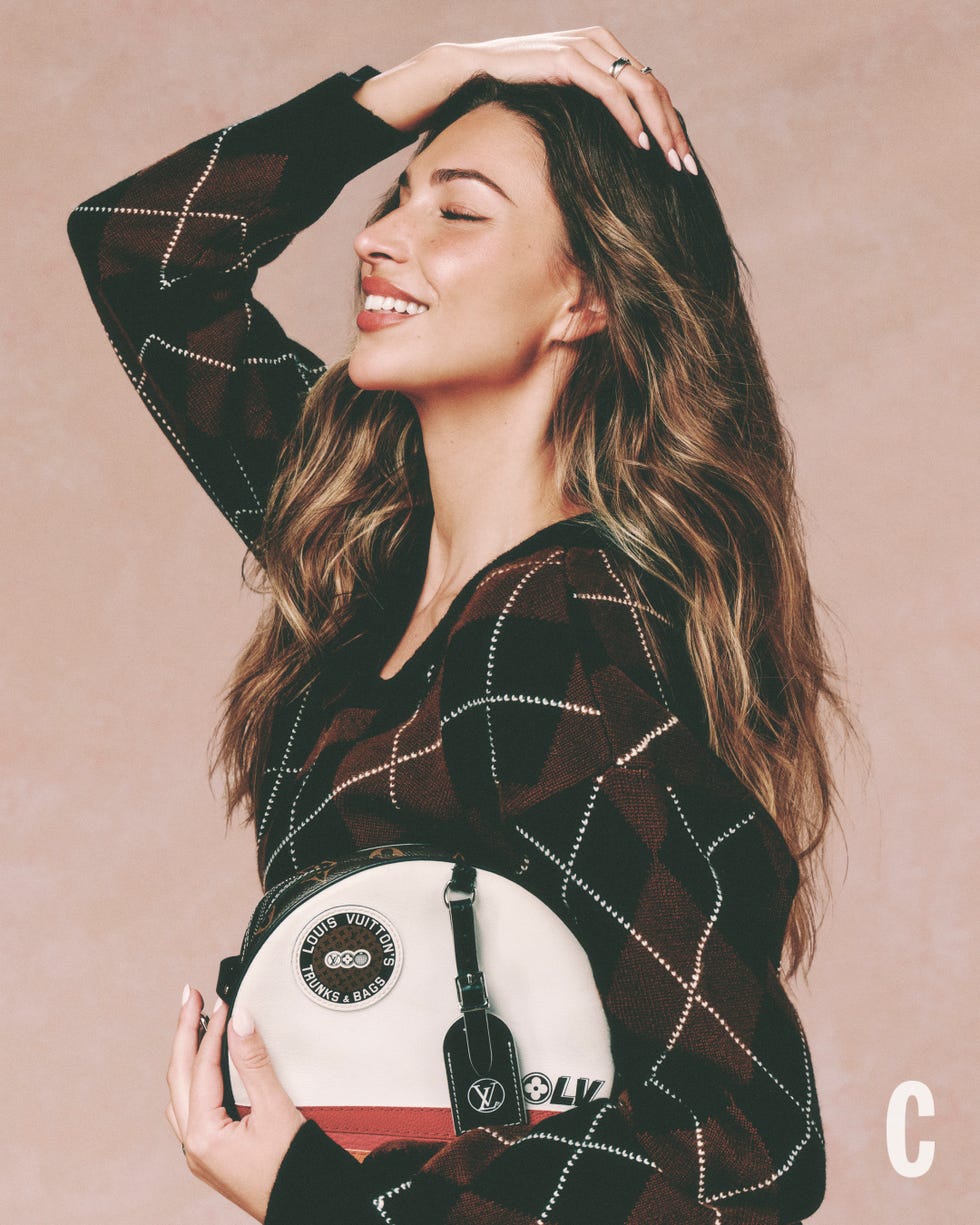 smiling woman with closed eyes holding a designer handbag. smiling woman with closed eyes holding a designer handbag.