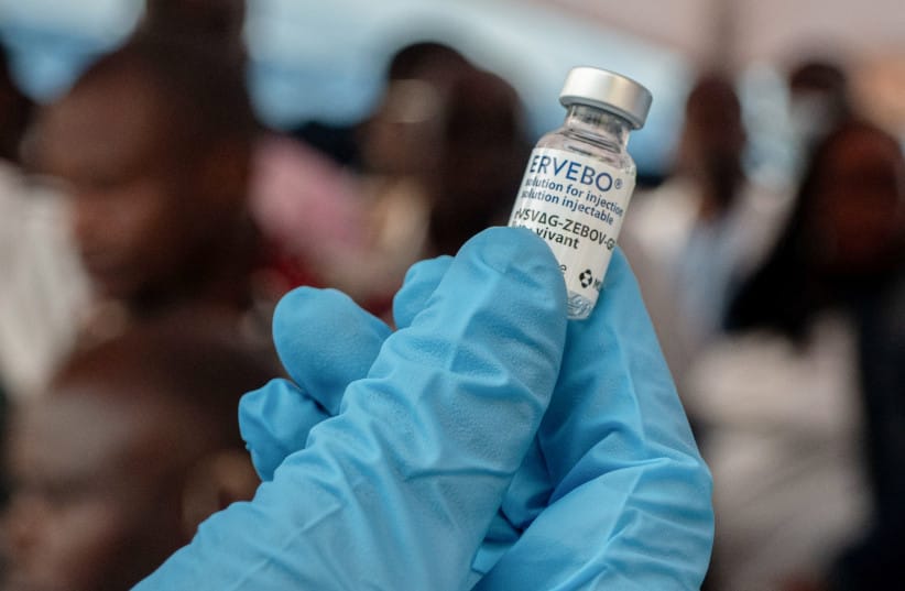 A Congolese worker holds an Ervebo vial as health and humanitarian responders on the front lines of the Ebola response receive a vaccination due to their potential exposure to the virus as part of their work with suspected cases, including contacts, as aid agencies intensify efforts to contain the E