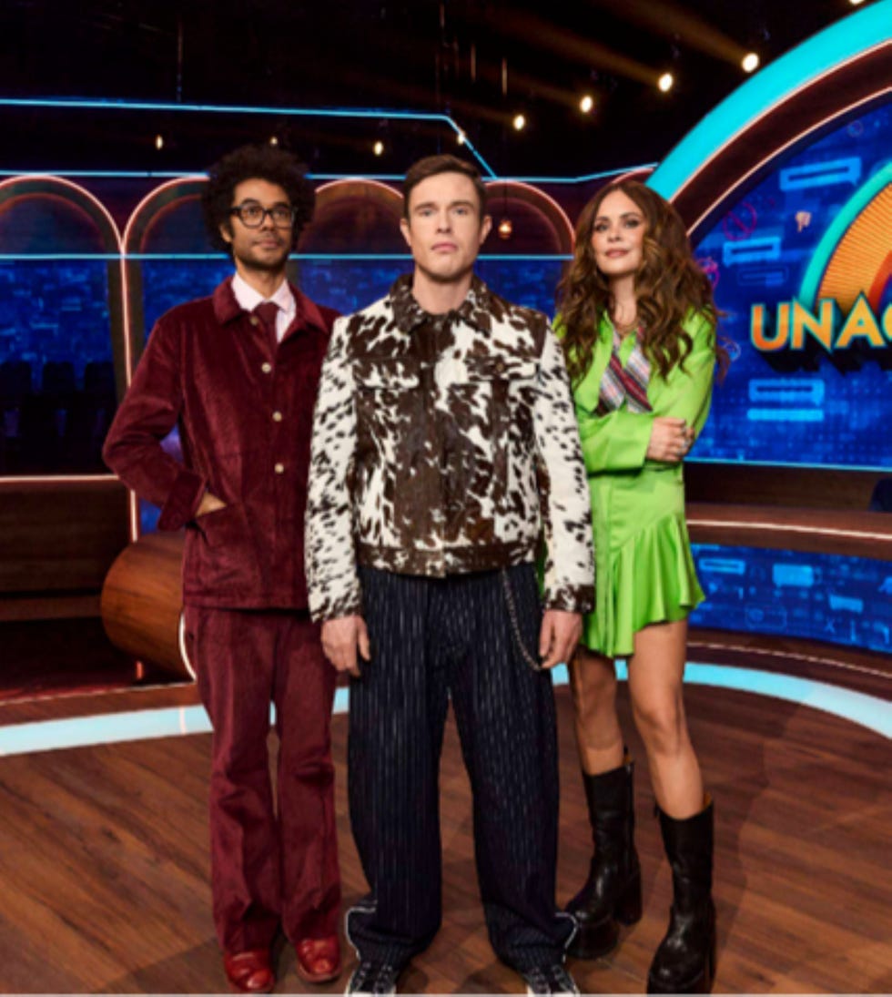 ed gamble unacceptable richard ayoade joanne mcnally three people standing on a stage with a colorful background.