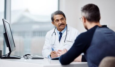 Physician discussing pulmonary tuberculosis treatment options with an adult patient during a consultation.