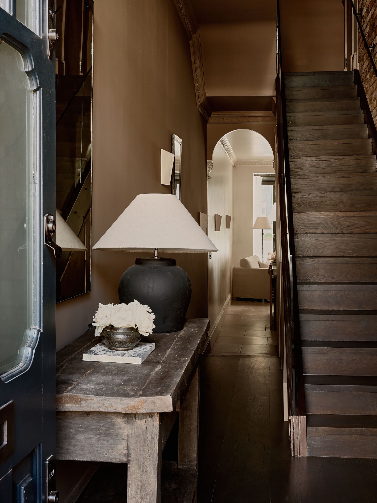 Image may contain Lamp Architecture Building Foyer Indoors House Housing Staircase Interior Design and Couch