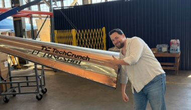Longshot CEO and cofounder Mike Grace with a projectile designed to be fired from his company's enormous gun.