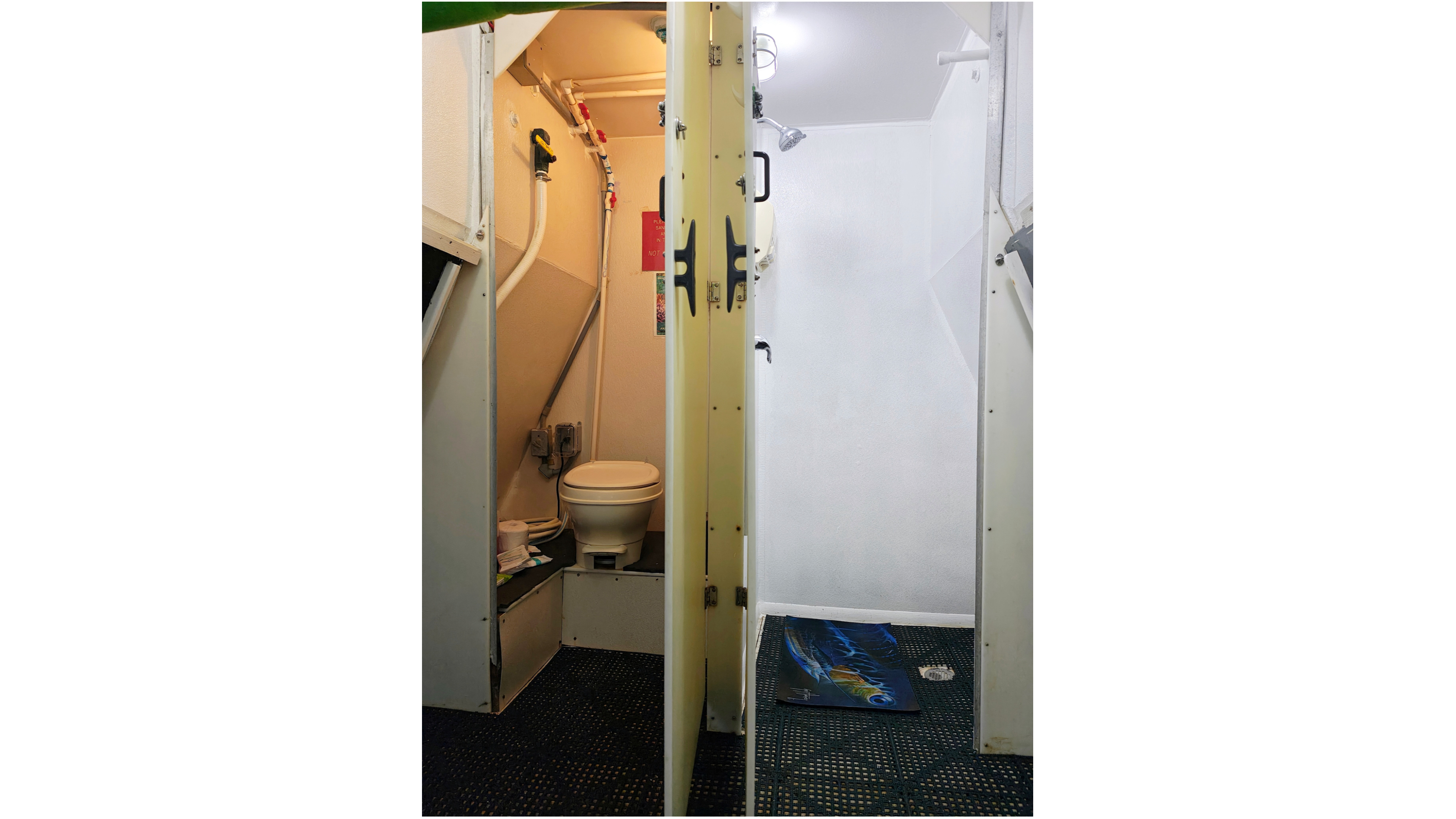 view of a toilet stall with the door open