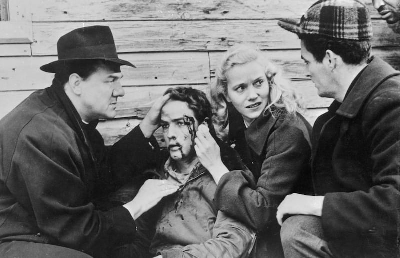 Father Barry (Karl Malden) realises that Terry (Marlon Brando) will be all right after a brutal beating by a waterfront racketeer, as Edie (Eva Marie Saint) stands by in the 1954 film On the Waterfront. Photograph: Bettmann Archive