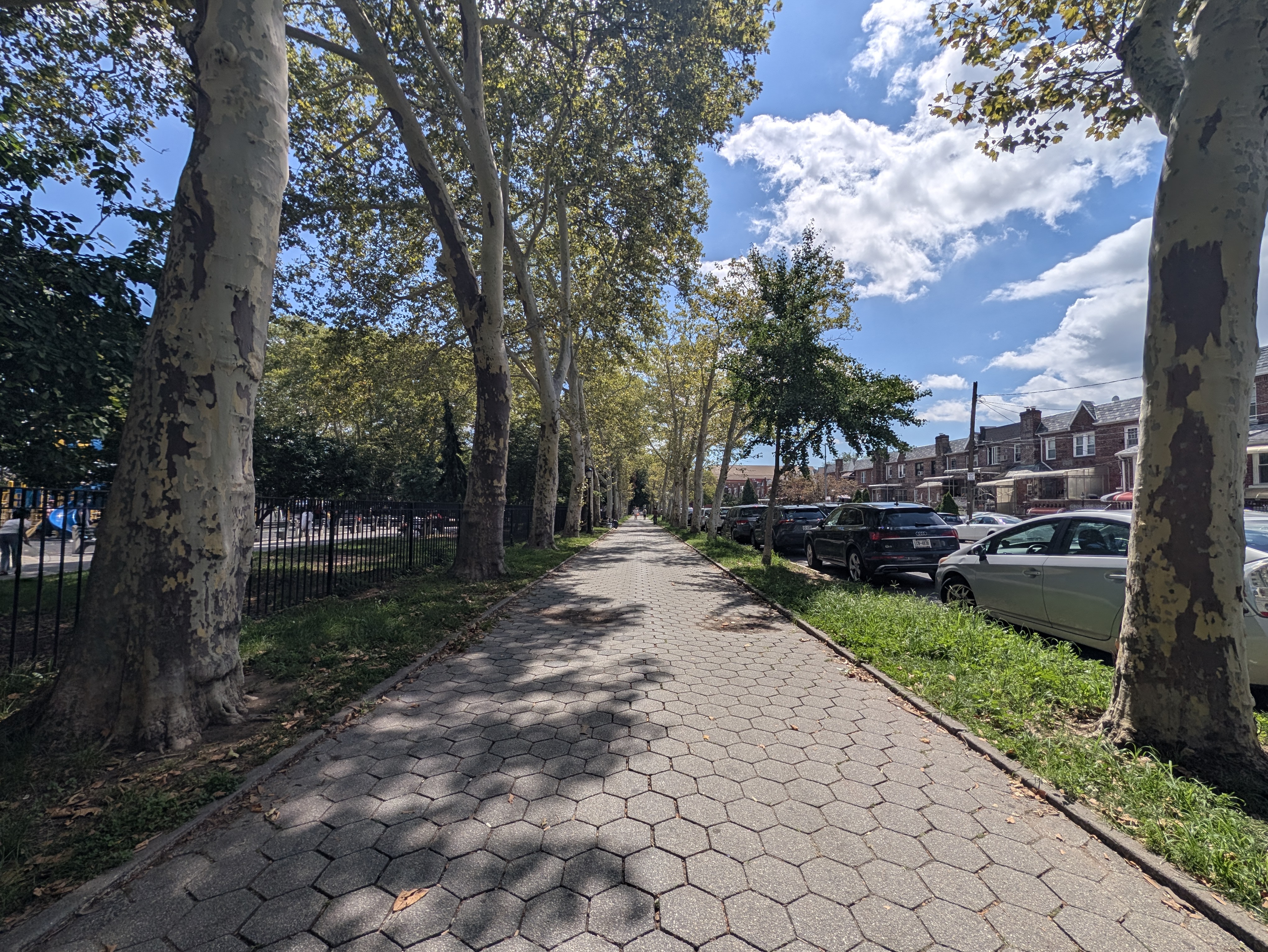 The sidewalk of a park.