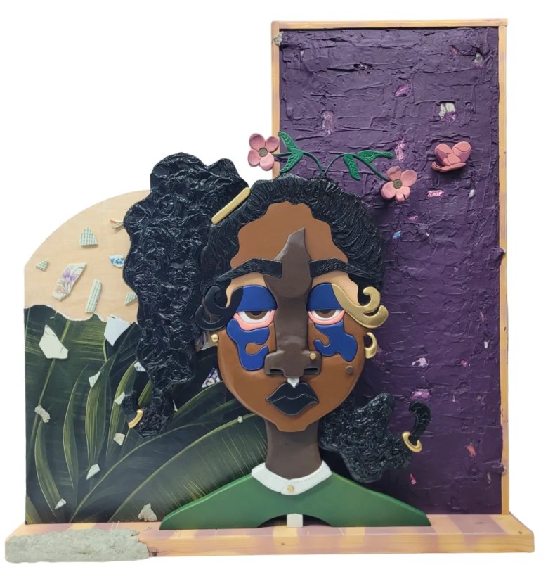 "The House I Carried" (19 words): Carved wood portrait bust with blue shapes around the eyes, set against a textured purple wall and leaf wallpaper.
