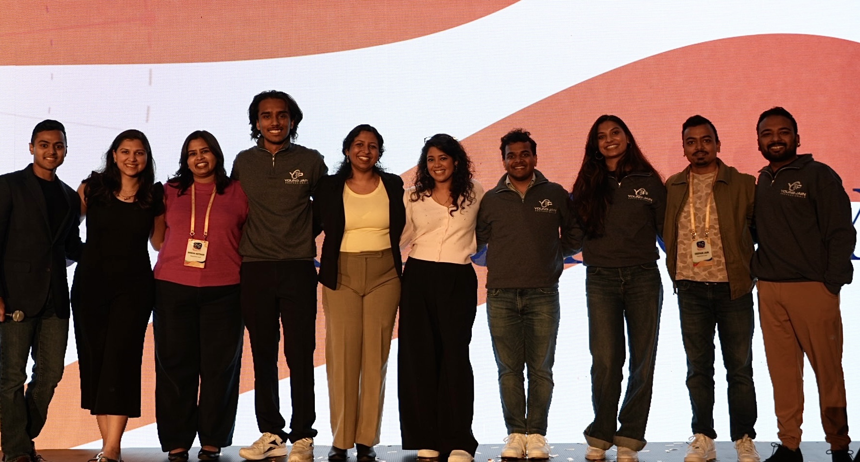 Members of the Young Jain Professionals (YJP) Convention Committee pose for a group photograph onstage during the YJP Convention 2026 in Milpitas, California.