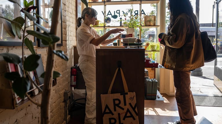 A customer purchases items at Art of Play.