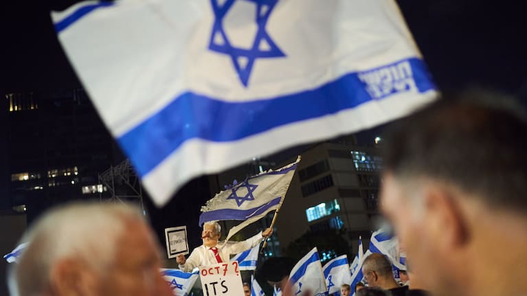 A demonstrator wearing a mask depicting Israeli Prime Minister Benjamin Netanyahu attends an anti-government protest.