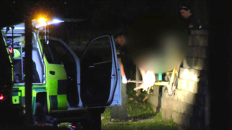 A person being removed from the property in west Auckland's Massey overnight.
