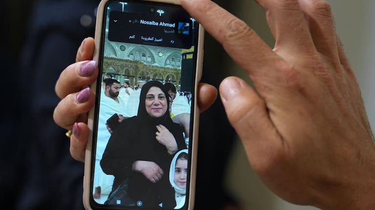 A portrait of Buthaina Ahmad Oweida, the Syrian woman who died in yesterday's attack on the Riyadh airport, is displayed on the mobile phone of her nephew at her family house.