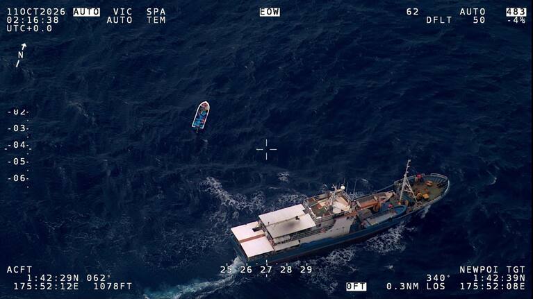 A vessel coming to the rescue of three people in a small boat off Kiribati. (Source: NZDF)